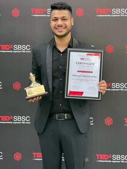 Holding my certificate and trophy after speaking and performing at TEDx SBSC. It was an honor to share my ideas and my magic on the iconic TEDx stage.