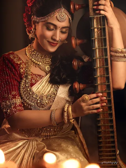 A serene and artistic portrait featuring a model with a traditional veena. The composition and lighting are designed to evoke a sense of classical grace and cultural heritage, making it suitable for fine art prints or culturally themed projects.