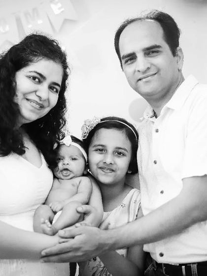 Another beautiful family portrait with their newborn and older daughter, captured in timeless black and white at their home.