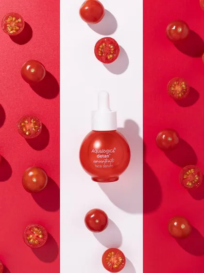 A bold, graphic composition for a bold product. We used a tri-panel background of red and white to frame the serum bottle, with fresh cherry tomatoes adding a pop of natural color and reinforcing the key ingredient story.