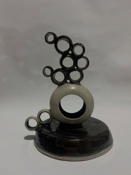One of the abstract sculptures I exhibited. This piece is made of interconnected rings, creating a sense of lightness and balance.