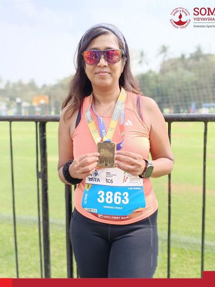 Dr. Vrushali Deole shows her finisher's medal after completing the 42 km Full Marathon at the Tata Mumbai Marathon 2026.