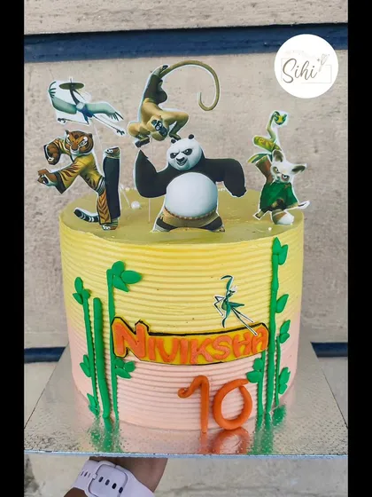 Everybody was Kung Fu fighting. This fun Kung Fu Panda cake features the whole gang as edible cutouts, set against a bamboo-themed buttercream background.