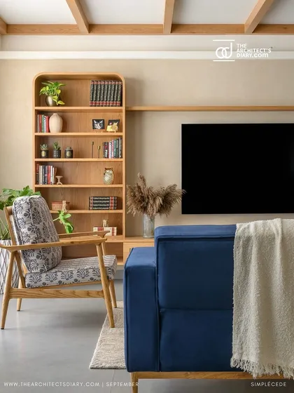 The living room in 'Cover me in Sunshine' features a custom arched bookshelf next to the TV unit, continuing the home's motif of curves and straight lines.
