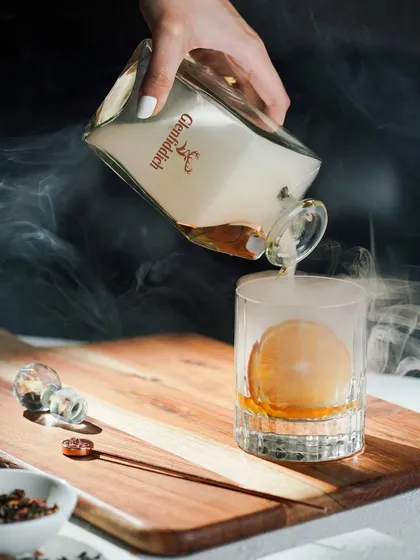 I create dramatic, high-end visuals for luxury beverage brands. This shot uses smoke and focused lighting to create a sense of mystery and sophistication, elevating the experience of pouring a glass of fine whisky.