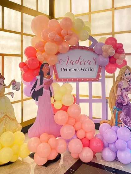 Another part of the Disney Princess party, featuring a "Princess World" sign and cutouts of Pocahontas and Rapunzel.