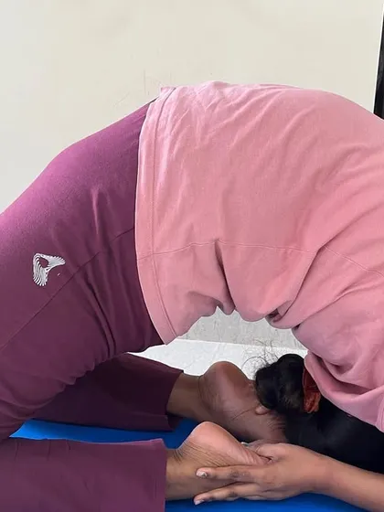 A close-up of a student in Kapotasana, showcasing the deep spinal arch and open shoulders required for this advanced posture.