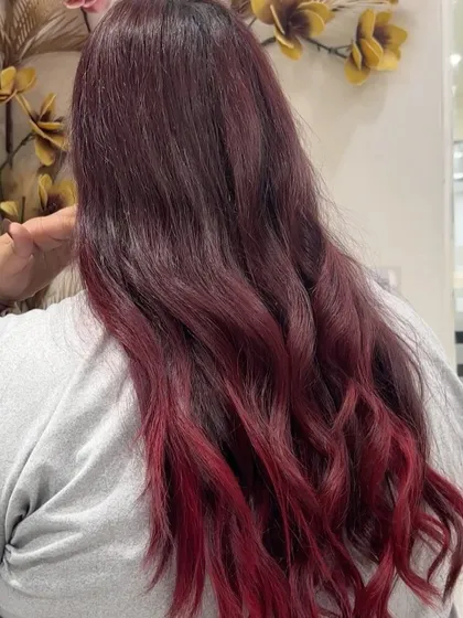A side view of the fiery red ombre, showing the seamless blend of colors and the healthy shine of the hair.