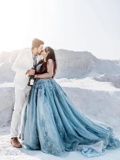 A romantic kiss captured during our clients' pre-wedding shoot. Her dusty blue ball gown with its flowing trail adds a touch of fairytale magic to this beautiful moment.