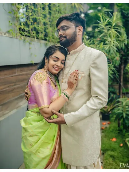 A sweet and tender embrace between Amruta and Varun on their engagement day, dressed in beautiful pastel traditional wear.