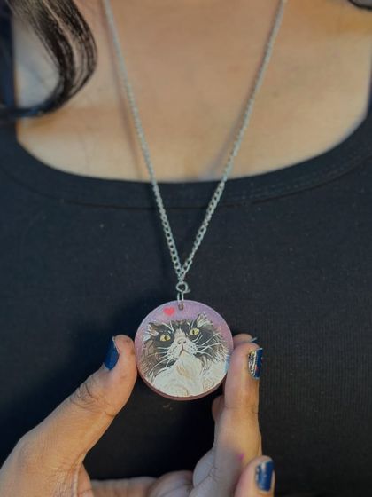 Another look at the custom pet portrait locket, a beautiful way to honor the bond with your fur baby.