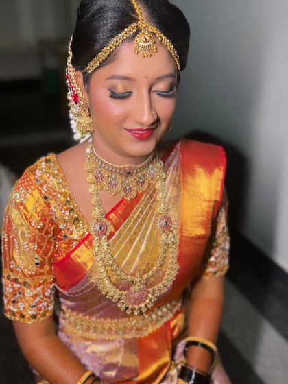 A close-up of Monika's eye makeup, featuring a touch of gold shimmer to match her saree and jewelry. The look is traditional yet fresh.