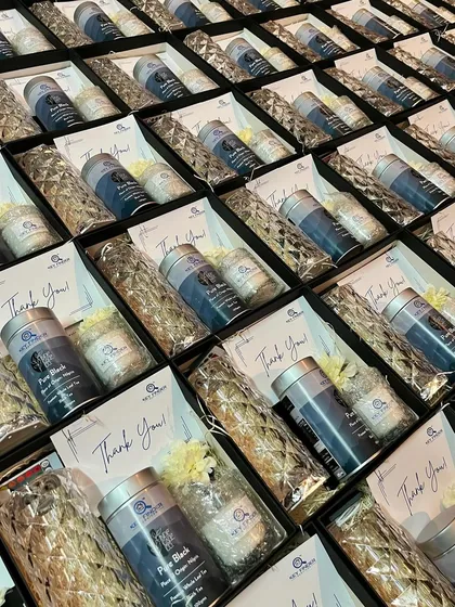 A closer look at a bulk order of employee appreciation gifts. Each box includes a "Thank You" card, scented candles, and other curated items to express gratitude.
