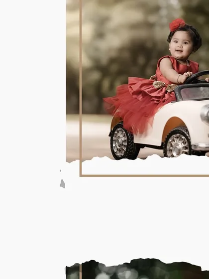 An artistic shot of a little girl in a red dress, enjoying her ride in a classic toy car. The creative framing adds a unique touch to this portrait.