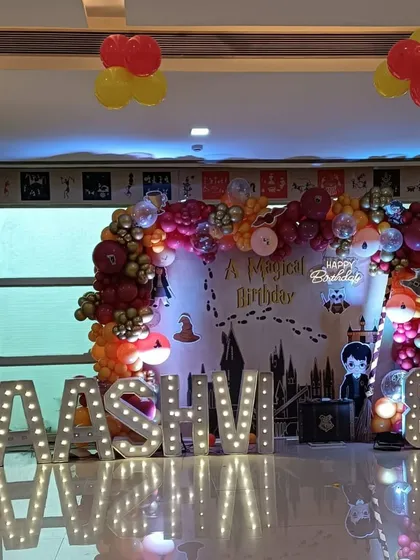 A magical birthday for a Harry Potter fan. This setup features a Hogwarts-themed backdrop, marquee letters spelling the birthday girl's name, and character cutouts.