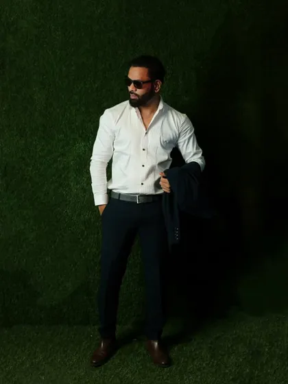 A smart-casual look with a crisp white shirt and formal trousers. This versatile style works for a wide range of semi-formal events.