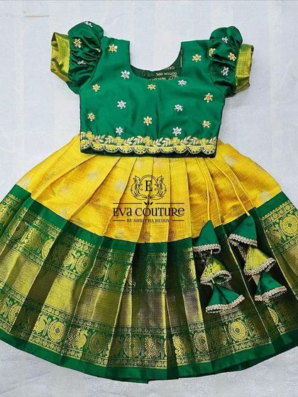 A classic green and yellow Pattu Pavadai, perfect for newborns and toddlers. The blouse has delicate embroidery, and the skirt has a wide zari border.
