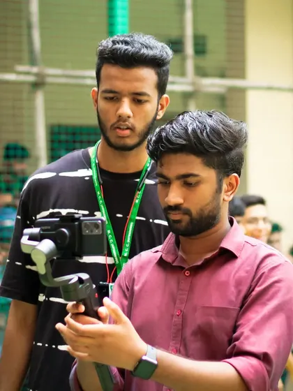 Working with a team member at a college event, explaining a shot on the gimbal. Teamwork is key to great coverage.