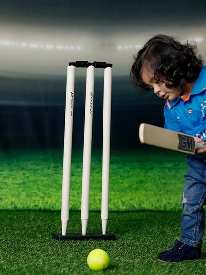 An action shot from the cricket-themed session. This toddler is focused on the ball, bat in hand, showing his budding passion for the game.