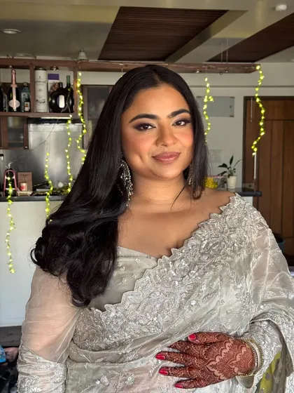 The same bride in a different light, showcasing her glowing skin and soft waves in a more relaxed setting. The makeup is versatile for any part of the wedding day.