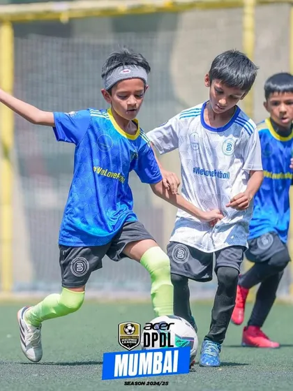 Feet on the field, eyes on the prize. A player shields the ball from a defender in a competitive DPDL match.