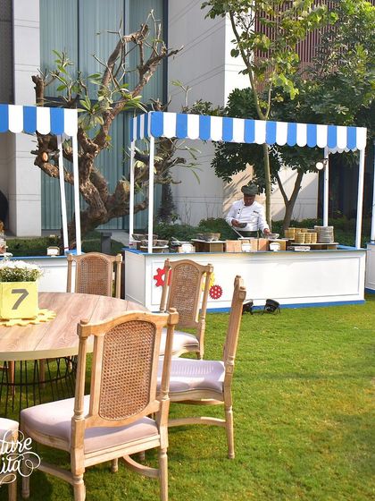 The food stalls were designed with blue and white striped awnings, keeping the look clean and cohesive with the overall party theme.