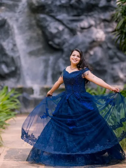 A happy, twirling pose in front of the waterfall, a perfect way to capture joy and movement.
