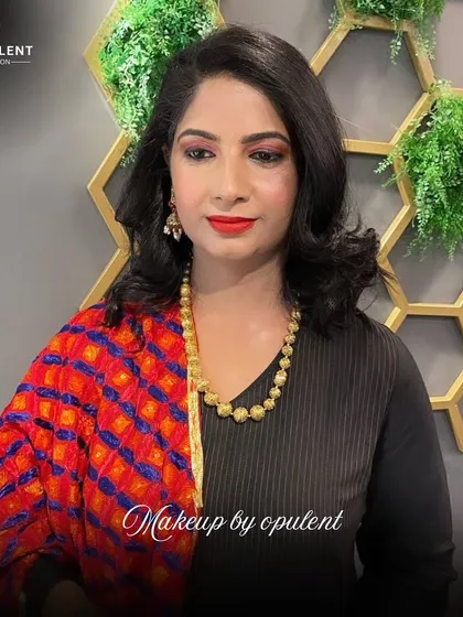 A classic look for any festive occasion. Here, we’ve paired a bold red lip with sharp winged eyeliner and softly styled hair, complemented by a colorful bandhani dupatta for a traditional yet chic vibe.