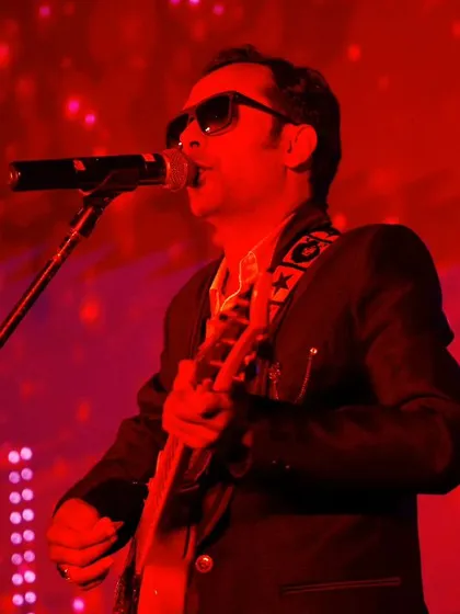 Our lead singer under the red lights, delivering a passionate performance at the EliteCISOs summit.