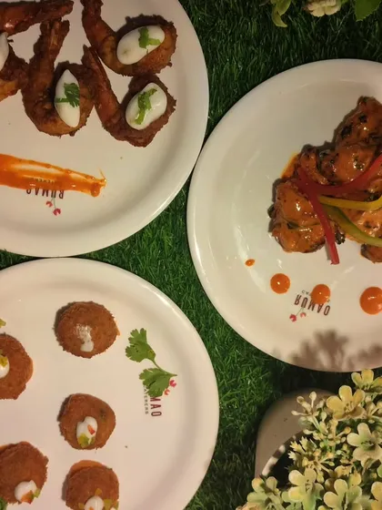 A trio of artfully plated appetizers. This image showcases my focus on presentation, with dishes like fried prawns and chicken tikka bites arranged with sauces and garnishes.