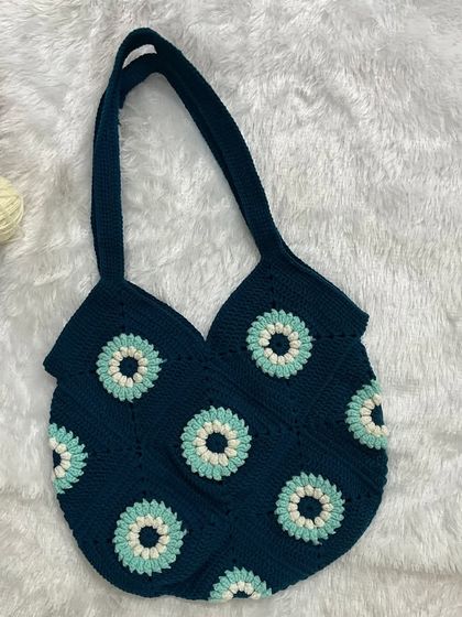 Here is another variation of my granny square tote, this time in a deep blue with a geometric floral pattern. I can create these bags in any color combination you like.