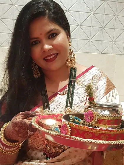 Throwback to my first Karwa Chauth. Holding the puja thali, I felt so grateful. My makeup was simple but festive, with a bold red lip and traditional gold jewelry to complete the look.