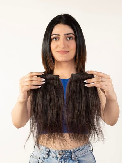 A clear, front-facing shot of a model holding the hair extensions, perfect for product detail pages.