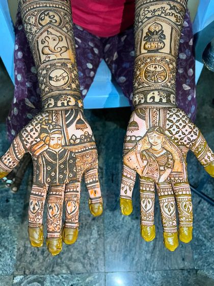 A full bridal mehendi set telling a complete story. This design features portraits of the bride and groom, along with auspicious symbols like Lord Ganesha and the couple's name.