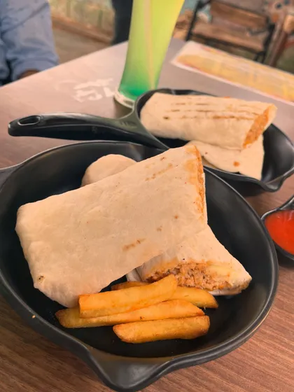 Our cafe serves a variety of delicious snacks and meals. After an exciting play session, you and your friends can relax on the patio with some tasty food, like these wraps and fries, while watching the dogs play.