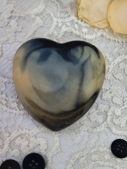 The deep, calming colors of the 'Lush Lavender' soap set against a lace background. This soap is a treat for both the skin and the senses.