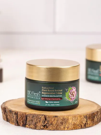 A product shot of Biofresh Botanicals' Regenerative Crème on a wooden slice. This styling emphasizes the product's natural ingredients and earthy connection.