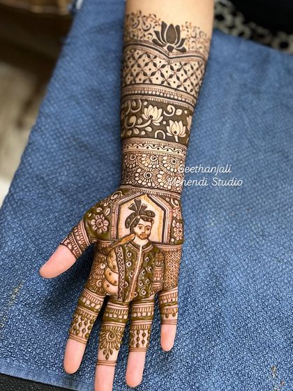 A portrait of the groom, ready for his wedding. This custom design was part of an intricate engagement mehendi, capturing his likeness in traditional attire.