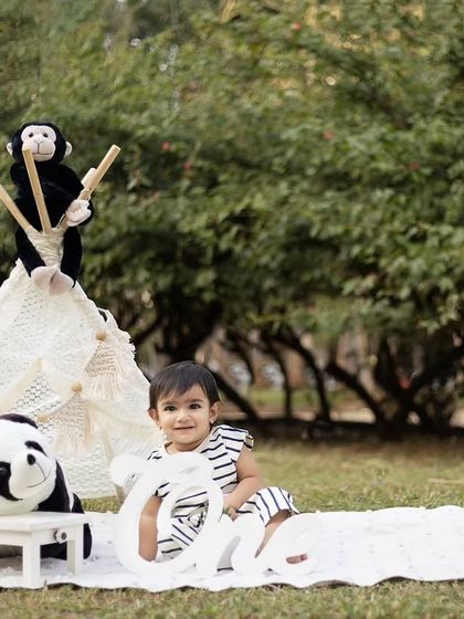 This little one is enjoying the outdoor setting, surrounded by her furry friends.