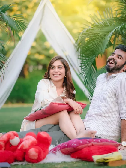 A candid shot of a couple laughing during their picnic-themed pre-wedding shoot. The genuine smiles and relaxed poses are what I aim to capture in every session.