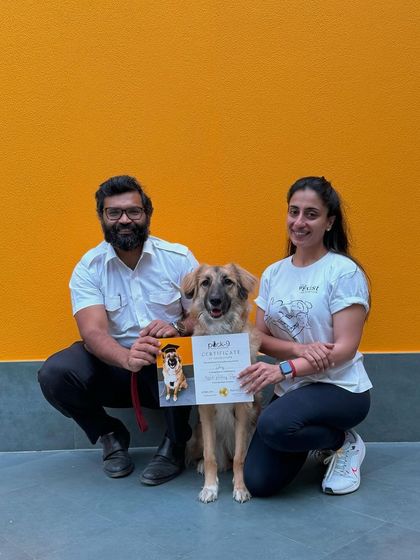 A proud graduation photo for Daisy the Himalayan Shepherd and her guardian.