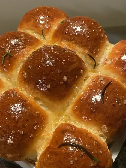 Fluffy, golden rosemary and sea salt brioche buns. I bake these fresh for my private dinners to be served alongside the meal.