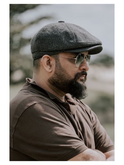 A profile shot taken outdoors. The natural light and thoughtful expression create a candid and approachable portrait.