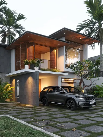 A view of a modern tropical home exterior that blends contemporary block forms with traditional sloping tiled roofs. The design incorporates natural materials like stone and wood, and the landscaping with palm trees completes the Kerala-inspired aesthetic.