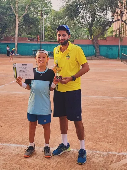 A young champion with his coach. We focus on nurturing talent from a very young age.