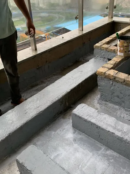 Applying a final layer of waterproofing coat to the custom-built planters and channels on a terrace to prevent any leakage.
