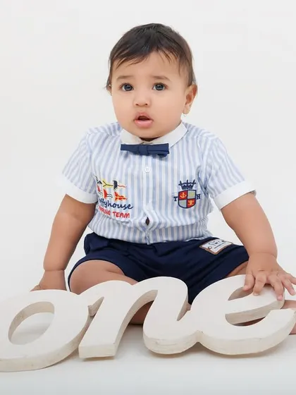 A simple and classic portrait of a one-year-old boy with a "one" prop.