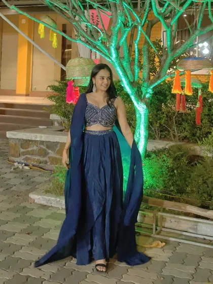 This navy blue cape set is a perfect example of my modern Indo-Western collection. It combines a beautifully embellished crop top and flowing skirt with a dramatic, floor-length cape for a look that is both regal and contemporary. It’s a comfortable yet stylish option for any wedding function.