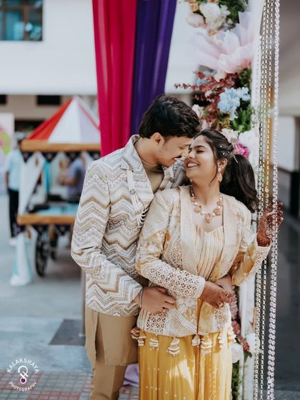 A happy, candid embrace between the couple at their fun-filled carnival party.