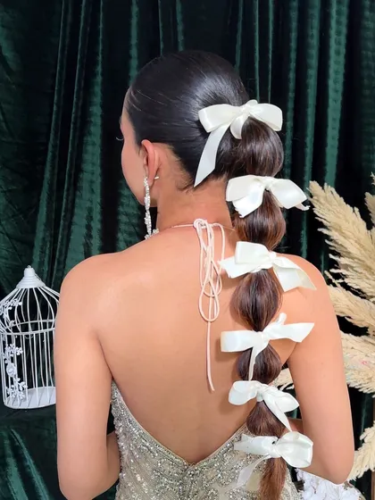 The back view of the balloon braid, adorned with classic white bows. I teach how to create the "balloon" effect and secure accessories for a clean finish.